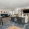 a clubroom with couches, tables, chairs and a tv