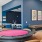 a room with a pool table and chairs